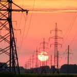 silhouette of electric post during sunset