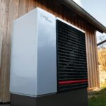 a white and black air conditioner sitting outside of a building