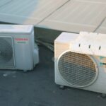 a couple of air conditioners sitting next to each other