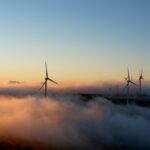 a group of wind turbines in the clouds